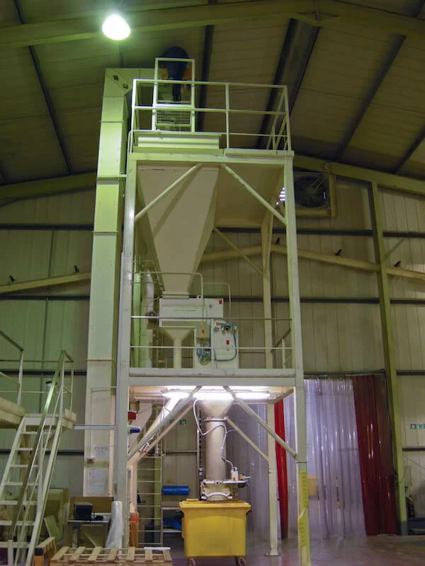 Bucket elevator feeding a hopper.