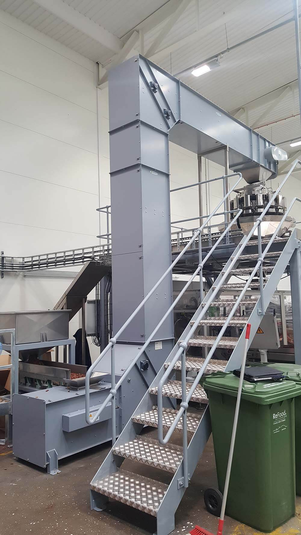 Bucket elevator feeding a multihead weigher.