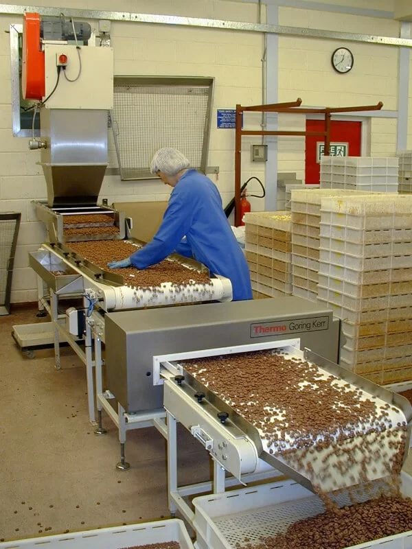 Belt conveyor and metal detector handling chocolate hoops.